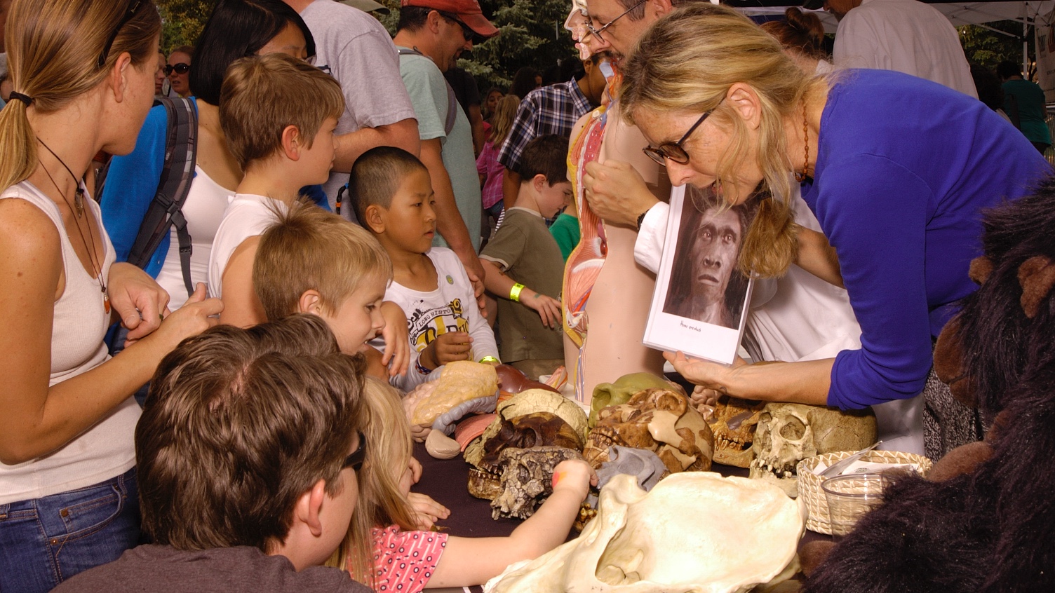 Teacher presenting fossils to children