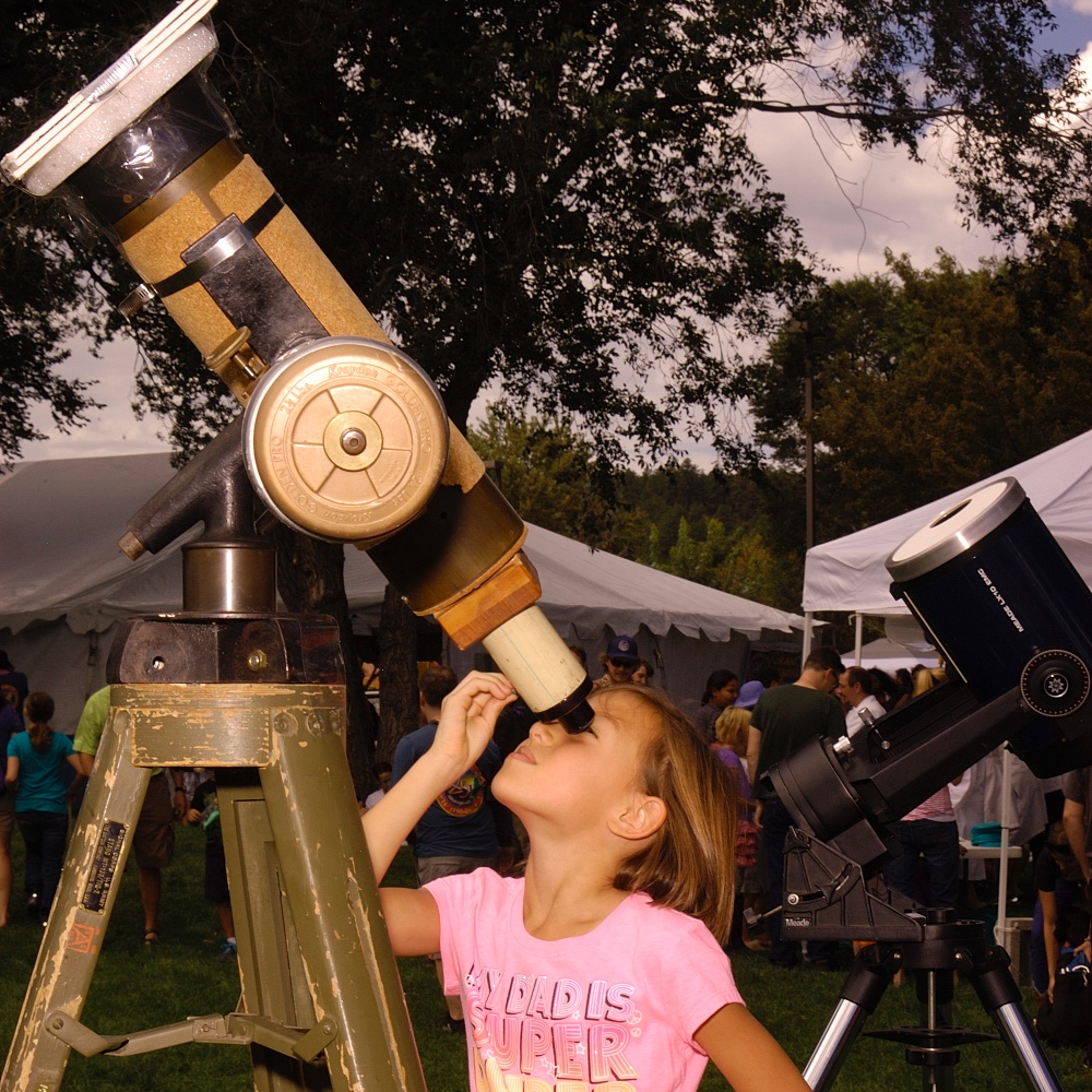 Girl viewing a telescope