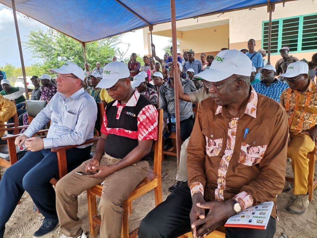 Henk sits with team members during a field trial demonstration