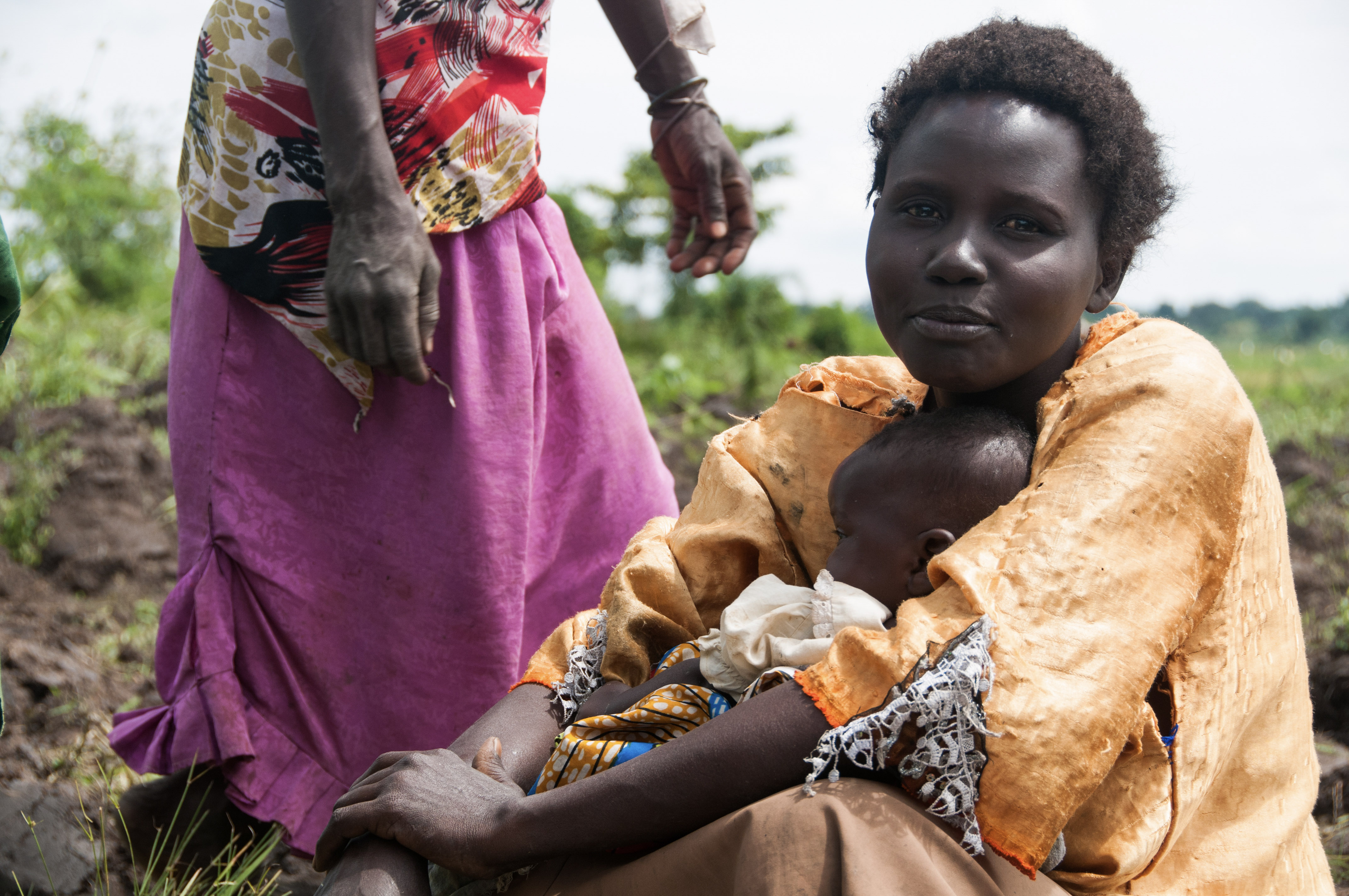 African Woman Smiling and holding baby