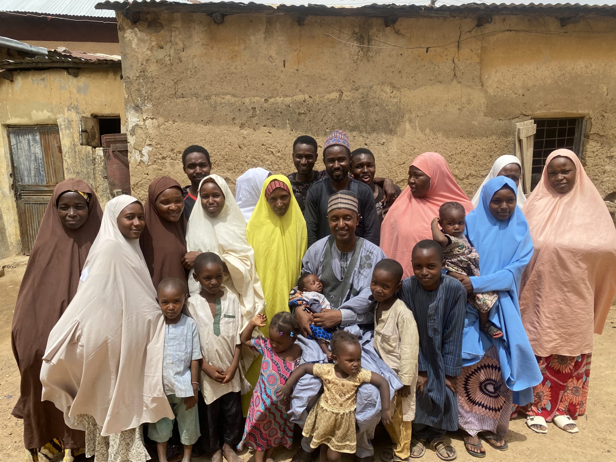 Dogara poses with his large family outside a building