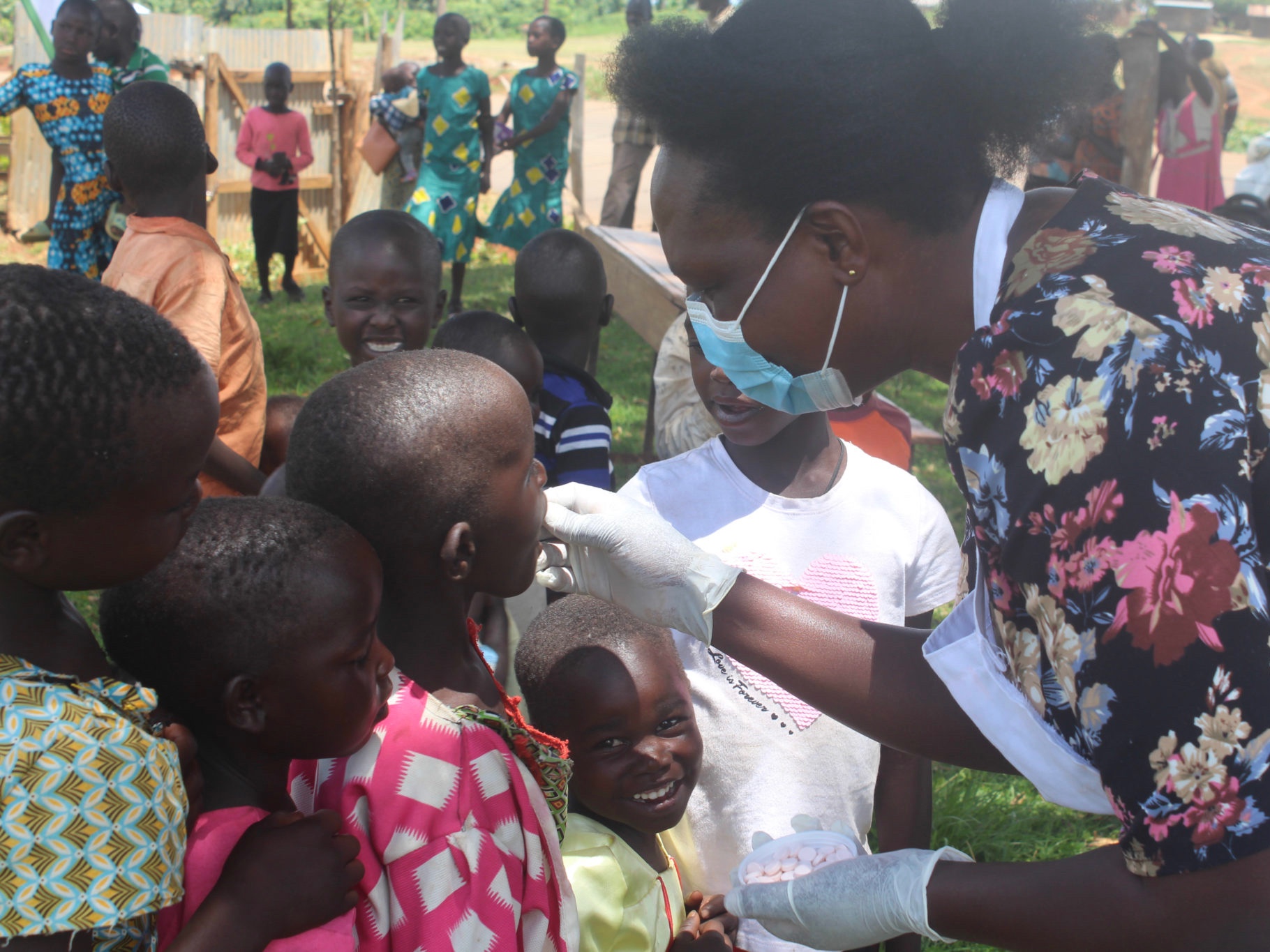 Nurse with children at Child Health Days in Uganda