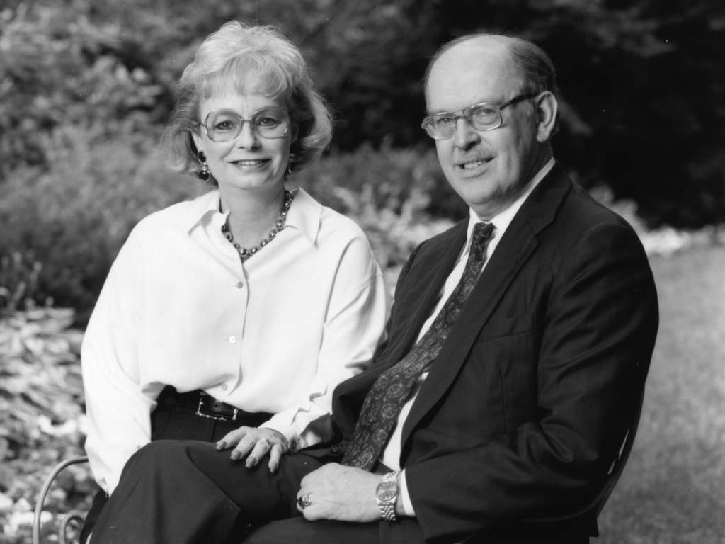 A black and white photo of Joanne and Peter McPherson sitting on a bench