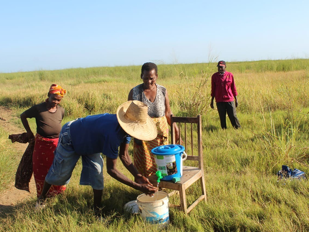 Farmers wash hands at a field washing station