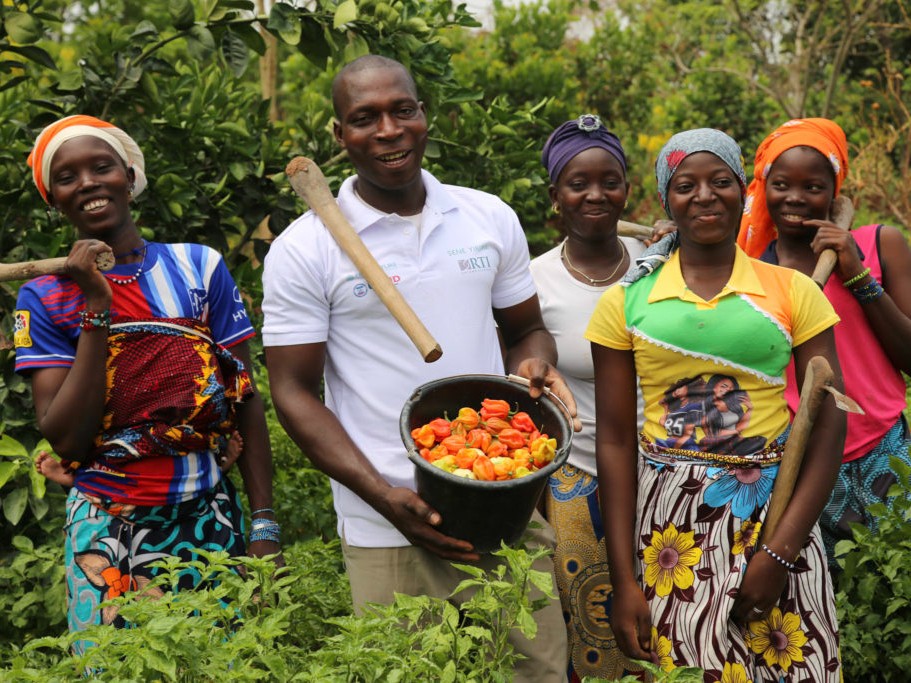 Three women and a man display peppers