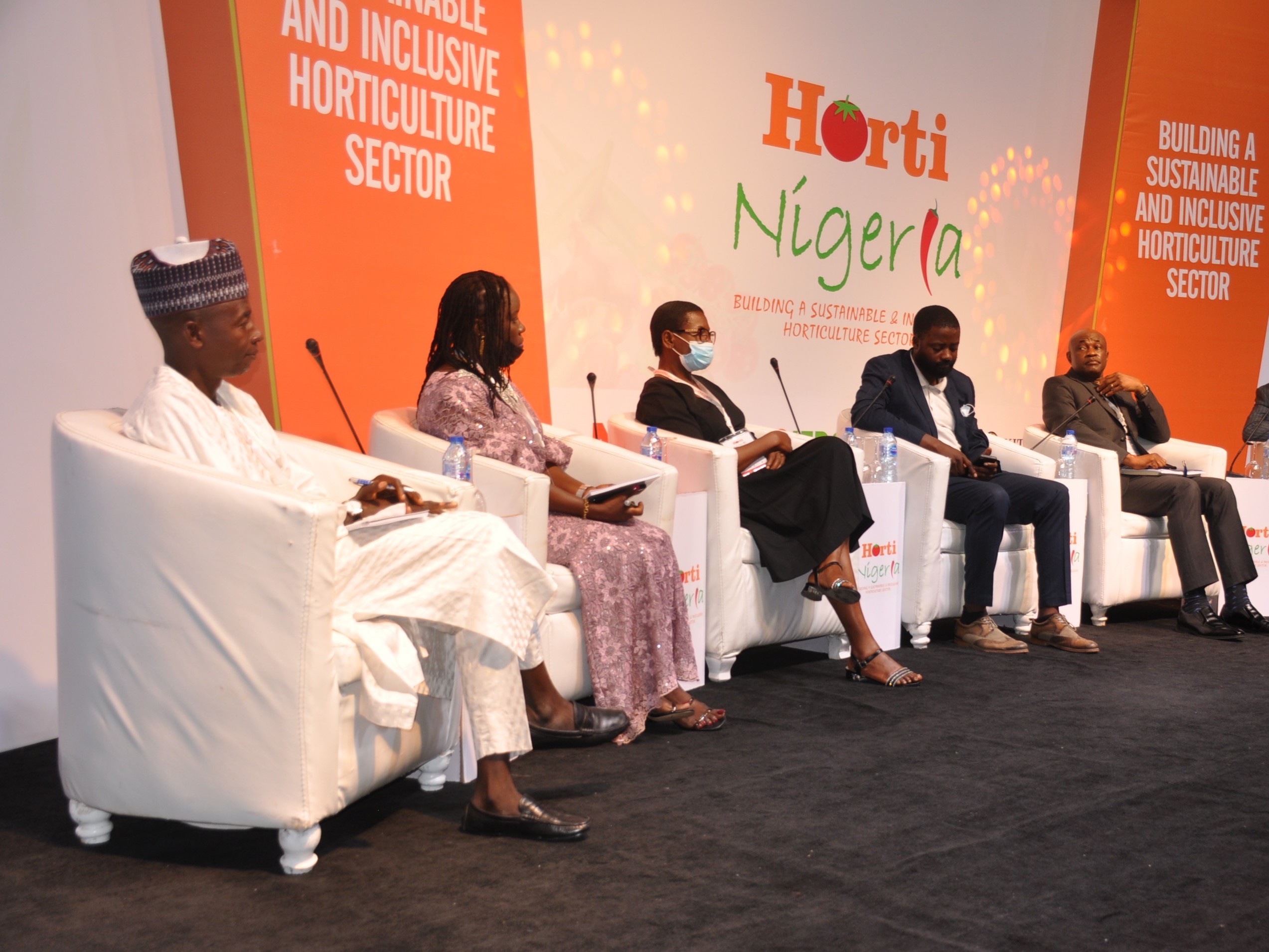 IFDC and partner representatives sit on the stage at the HortiNigeria program launch