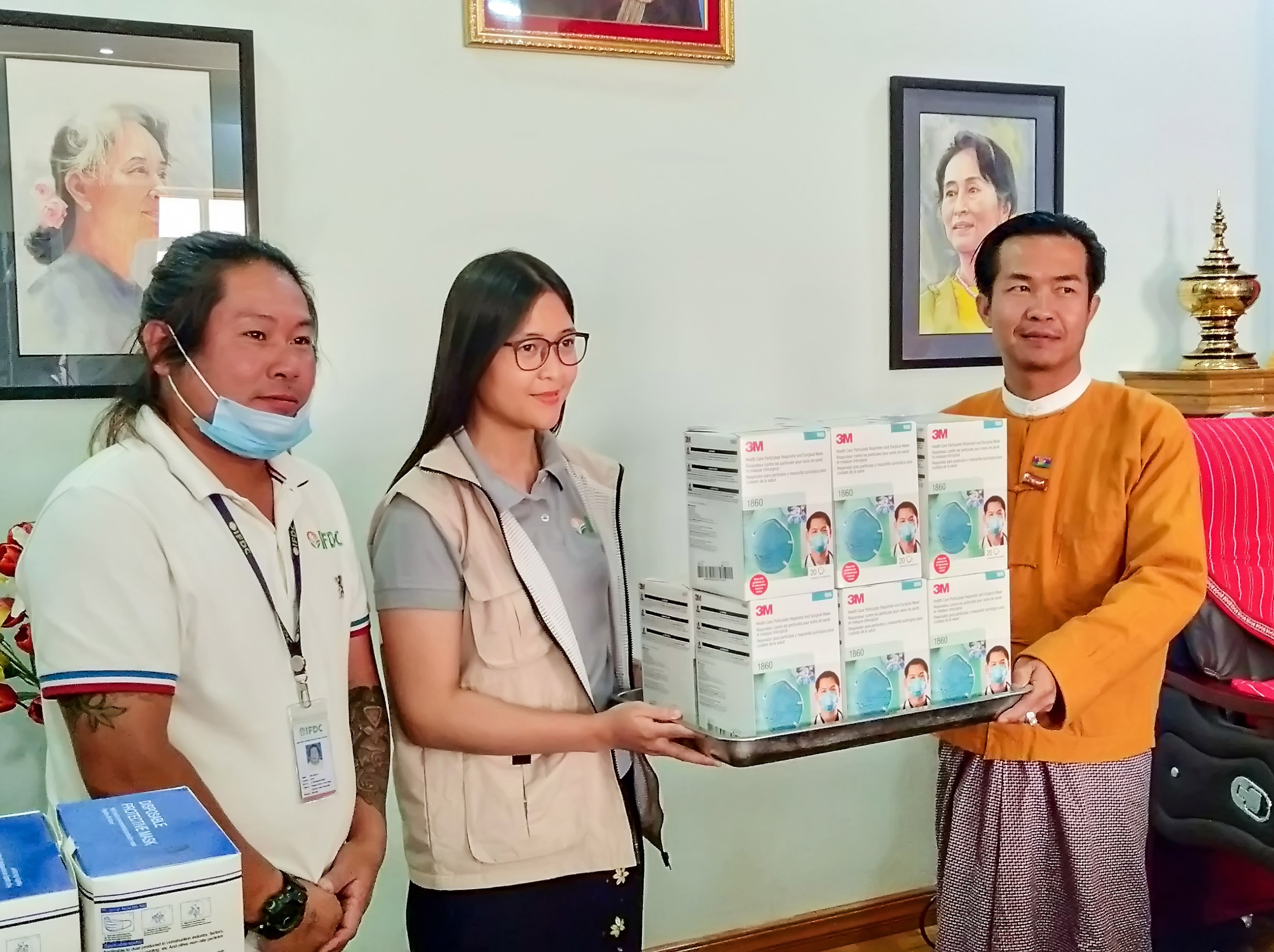 IFDC workers hand over PPE 