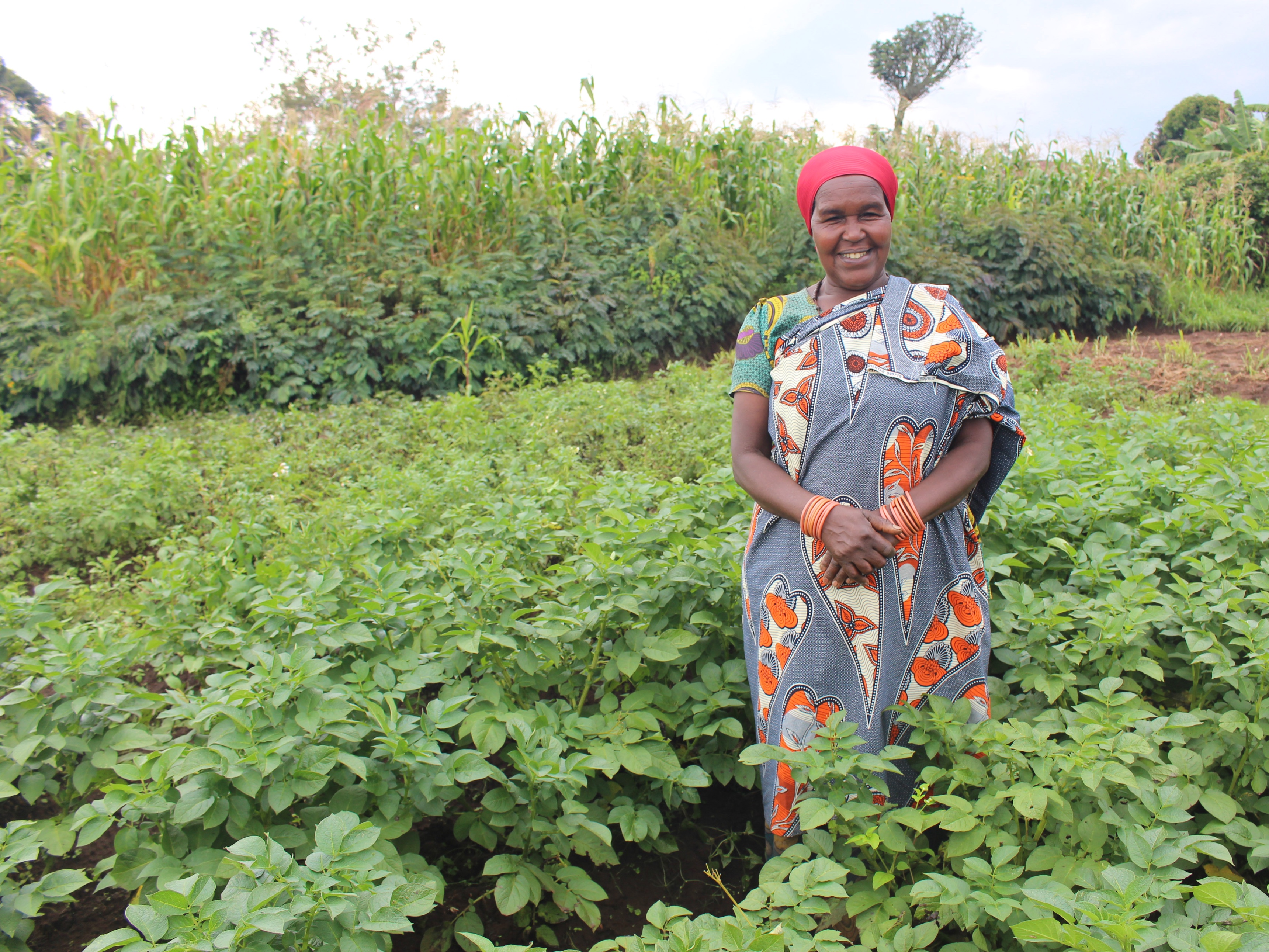 A PAGRIS participant stands in her field of healthy crops