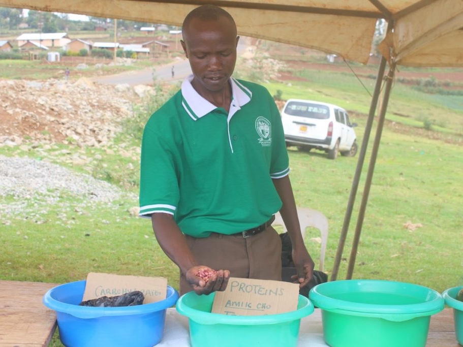 Ugandan man holds potato seed
