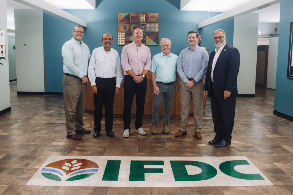 IFDC and Pursell representatives pose for picture in IFDC lobby