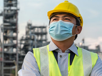A plant worker wears a mask