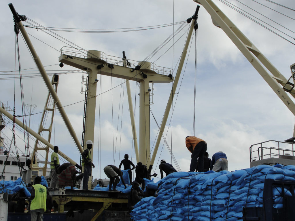 Men working on a ship transporting fertilizer