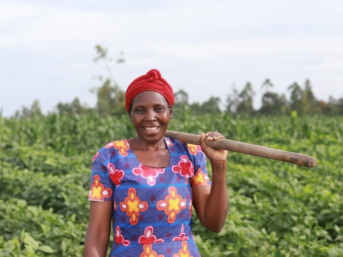 A Kenyan woman stands in a soy field