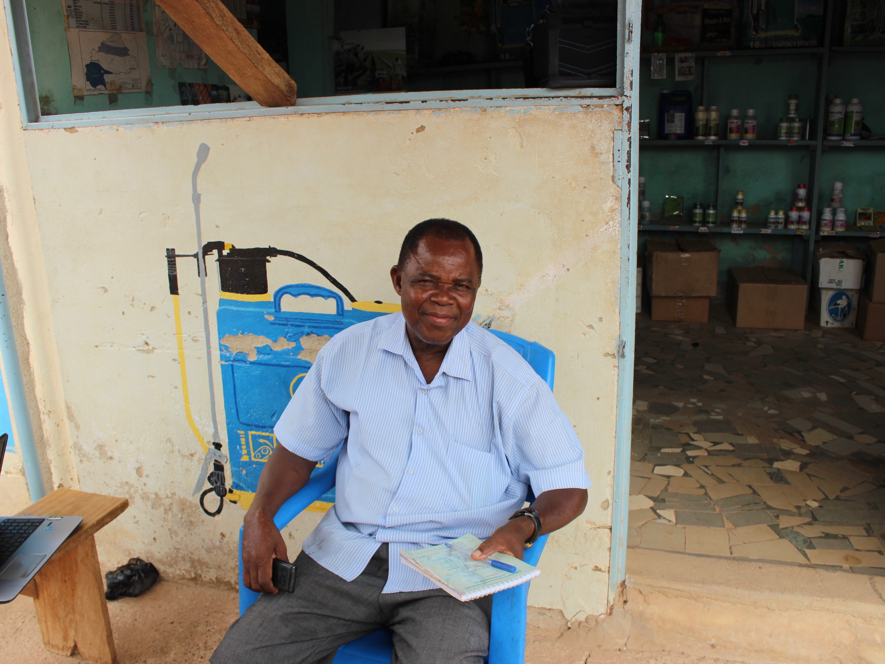 Agri-input dealer from Burkina Faso sits outside his shop there.