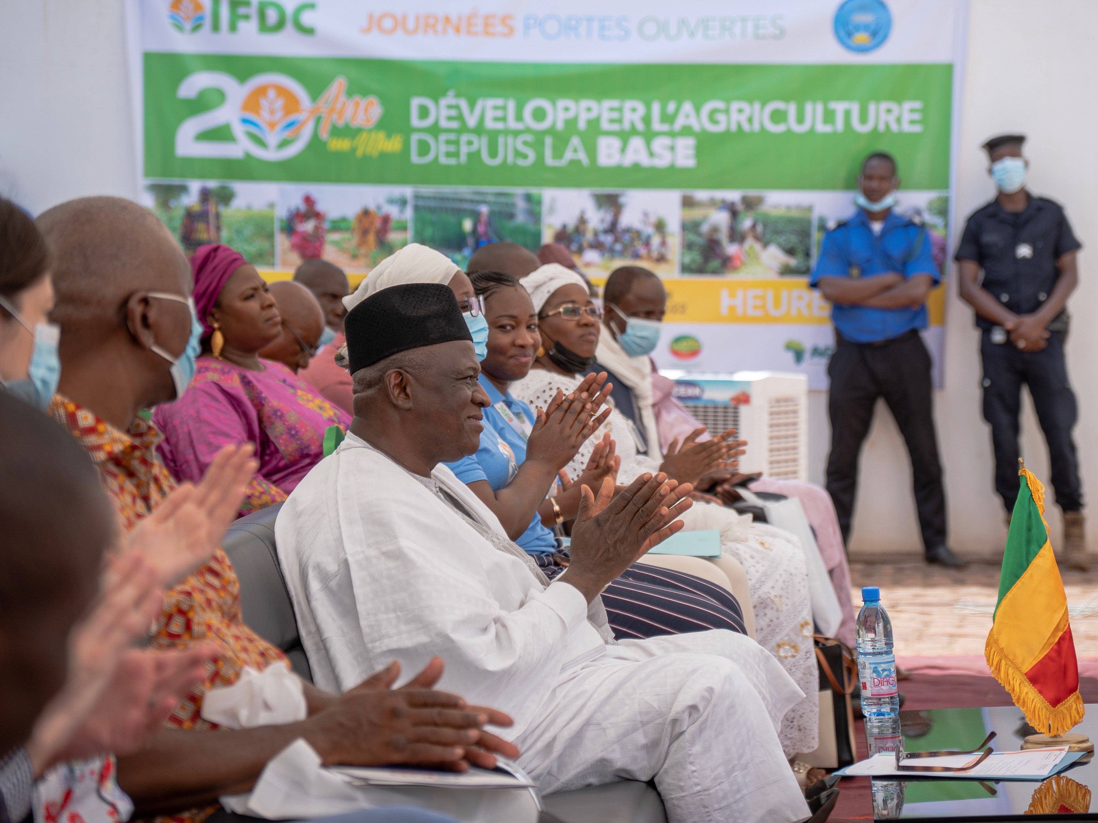 Open door attendees clap after a presentation is given