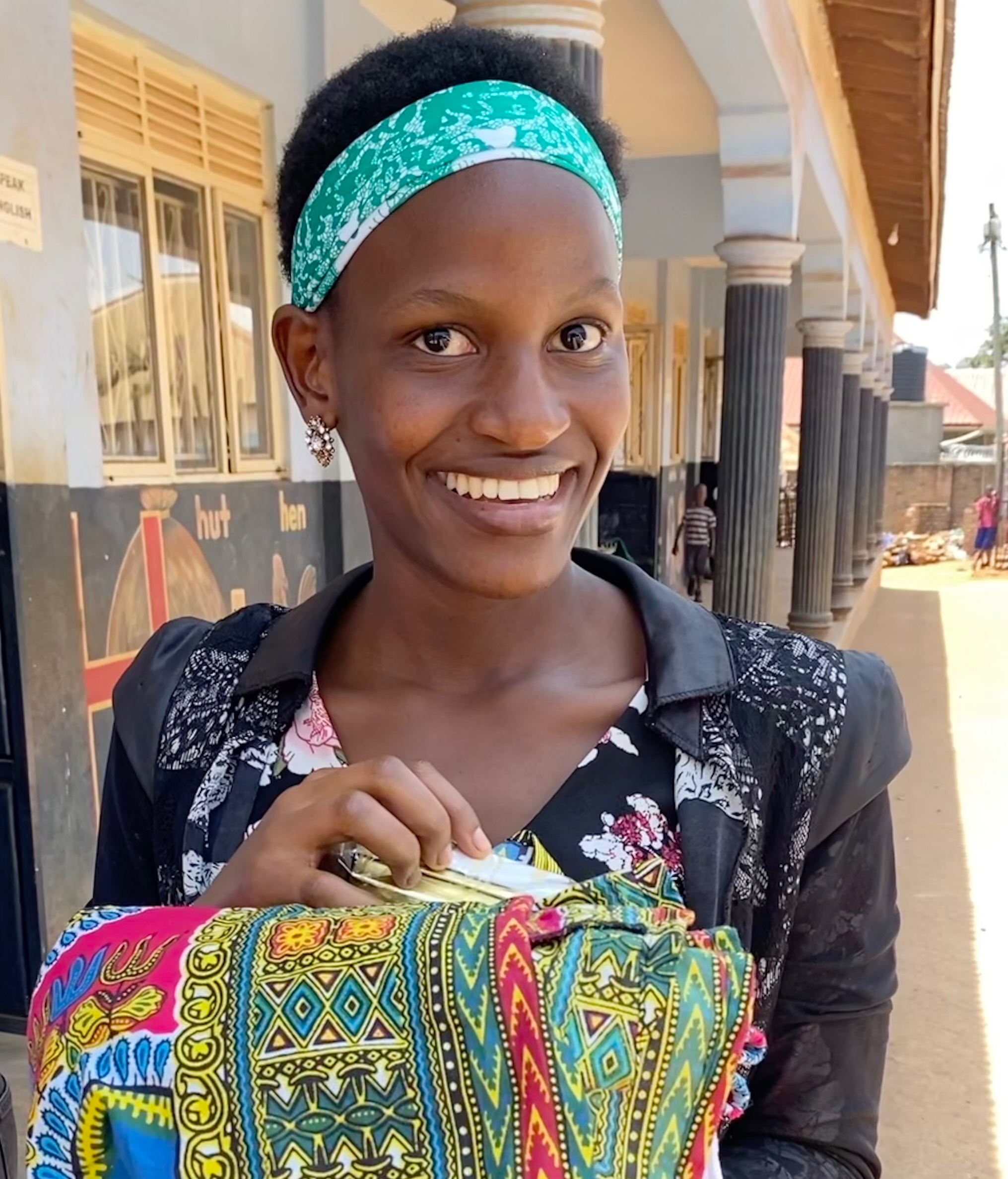 Young woman teacher outside of a school building