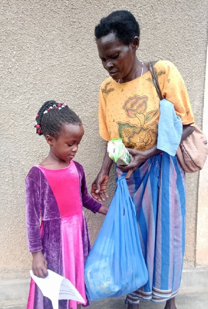 Grandmother with small Mustard Seed girl and big Christmas package.